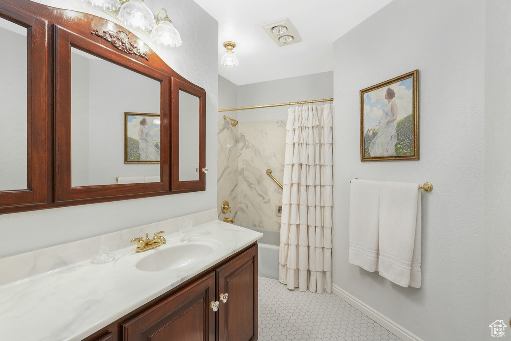 Bathroom featuring tile floors, shower / bath combo, and oversized vanity