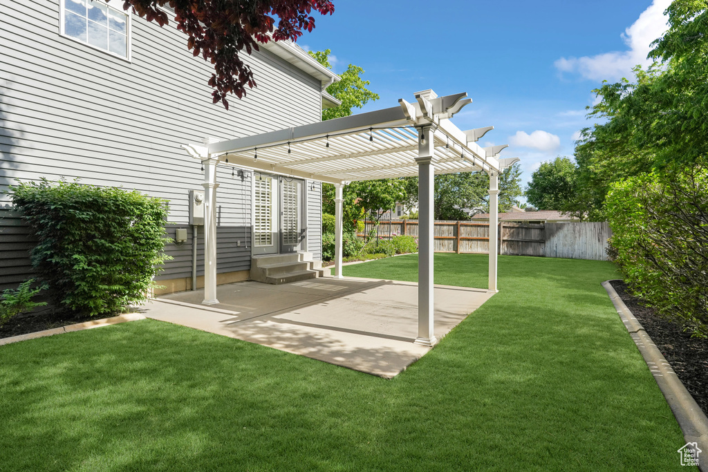 View of yard with a pergola and a patio area