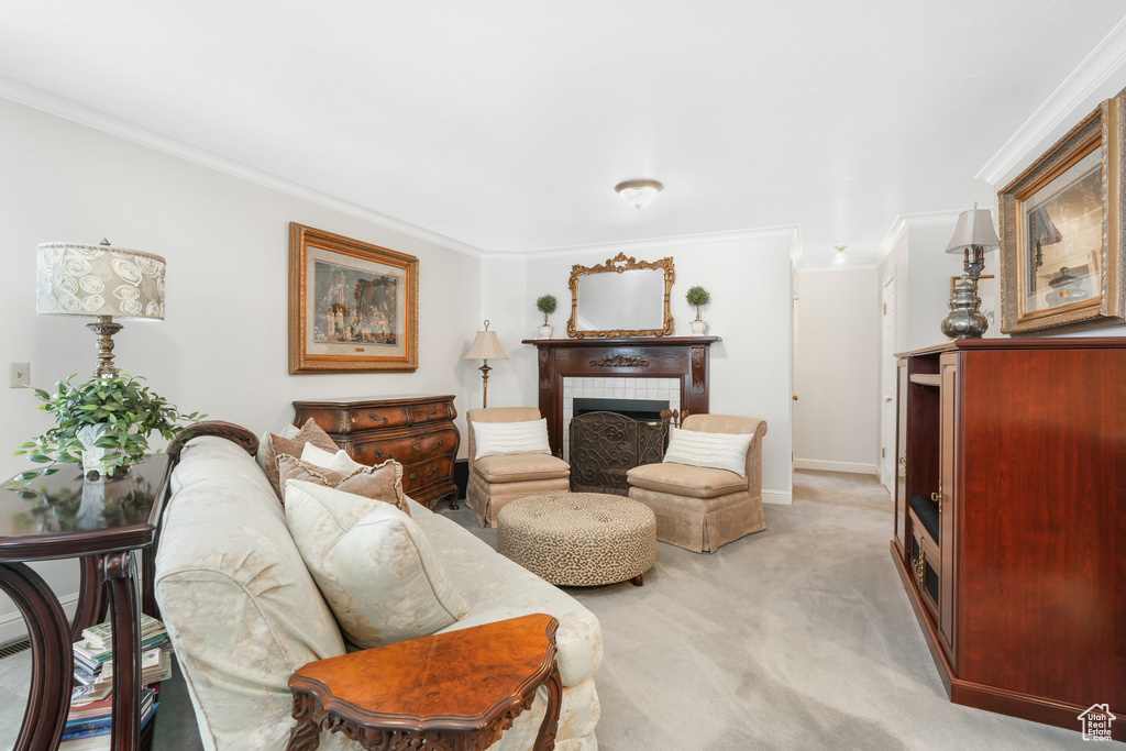 Living room with ornamental molding, a fireplace, and carpet floors