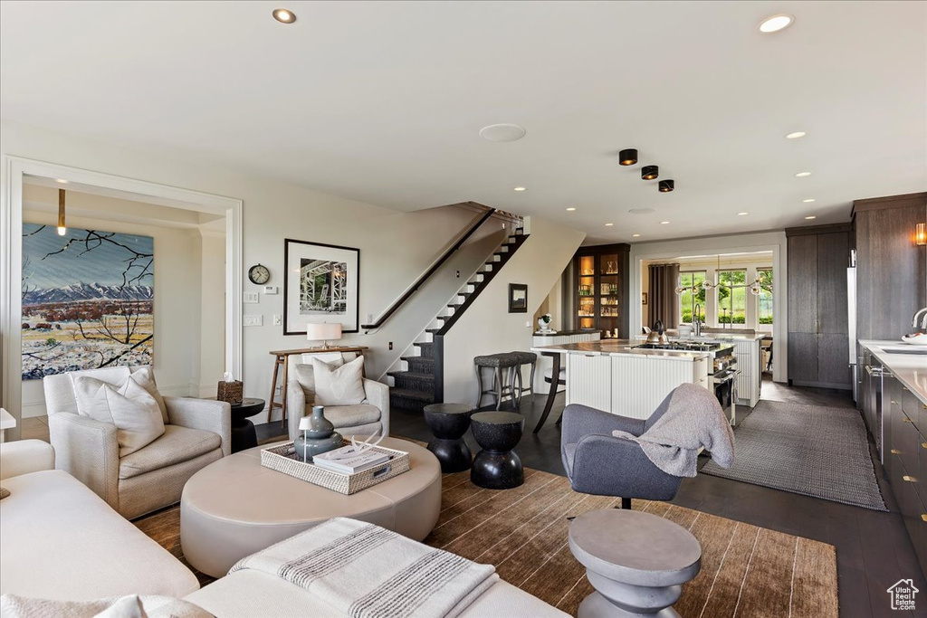 Living room with dark wood-type flooring