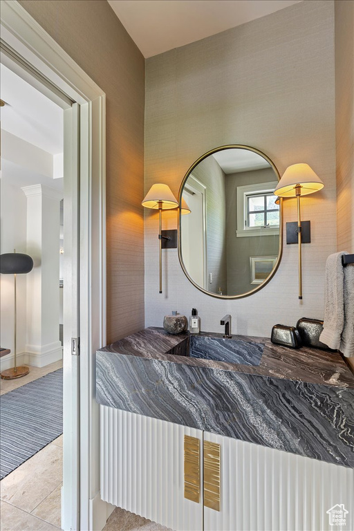 Bedroom with sink and light tile floors