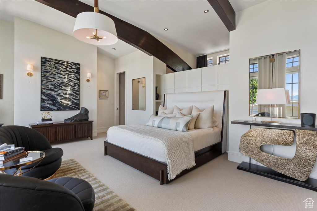 Carpeted bedroom featuring beamed ceiling and a high ceiling