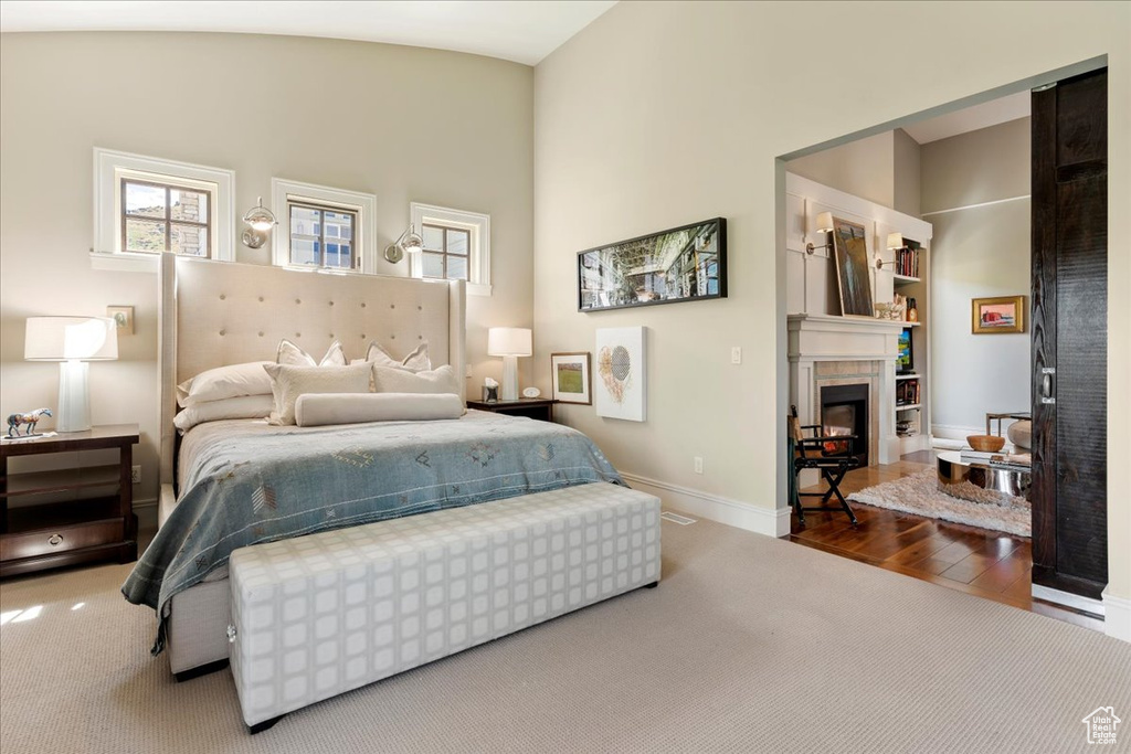 Carpeted bedroom featuring lofted ceiling