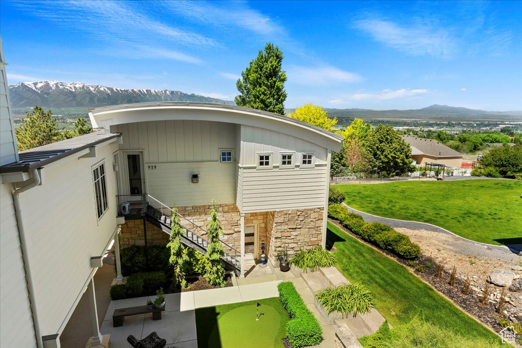 View of outdoor structure featuring a mountain view and a lawn