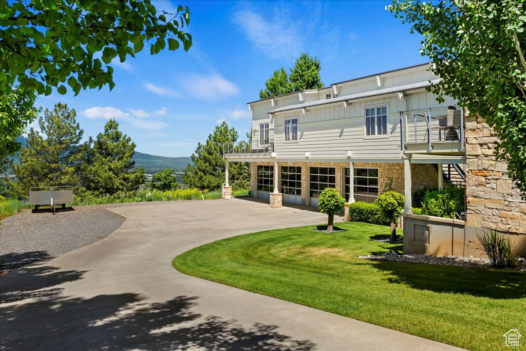 Rear view of property with a lawn