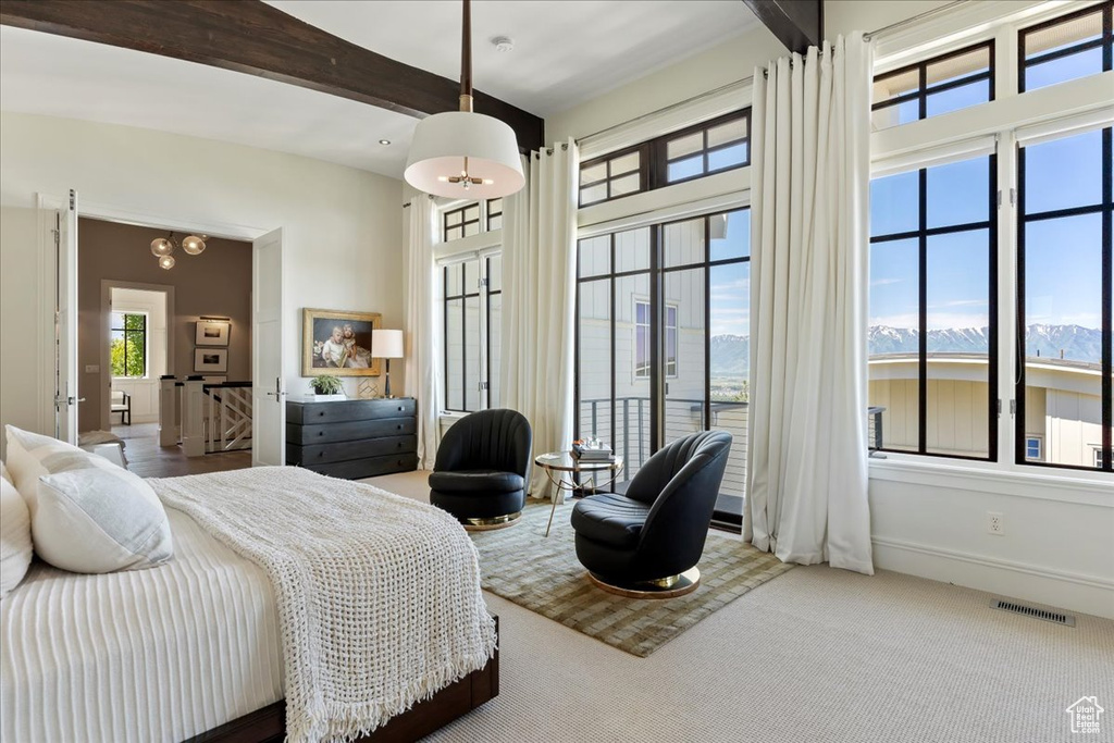 Bedroom featuring beamed ceiling and carpet floors