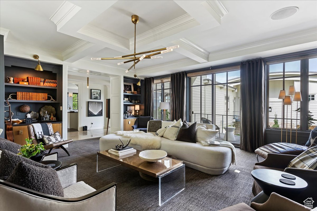 Tiled living room with a wealth of natural light, an inviting chandelier, coffered ceiling, and ornamental molding