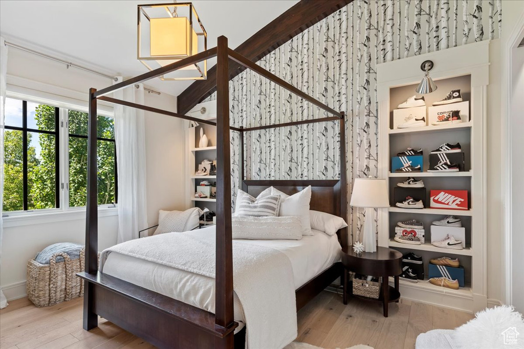 Bedroom with wood-type flooring and multiple windows