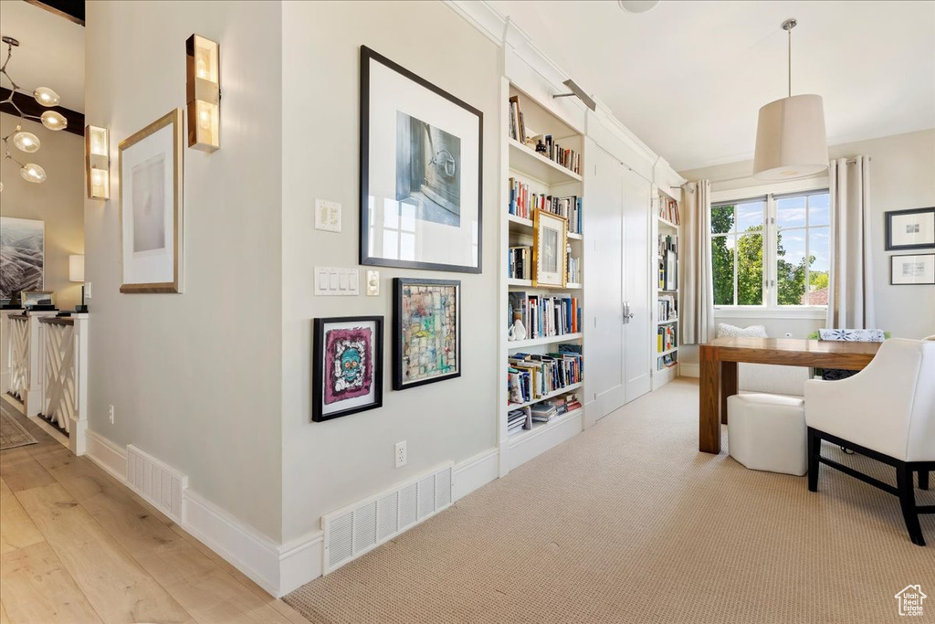 Interior space featuring built in shelves and light wood-type flooring