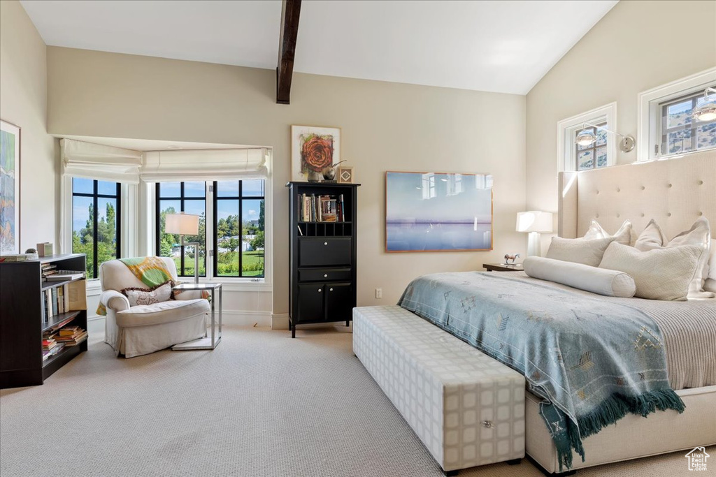 Bedroom with lofted ceiling with beams and carpet floors