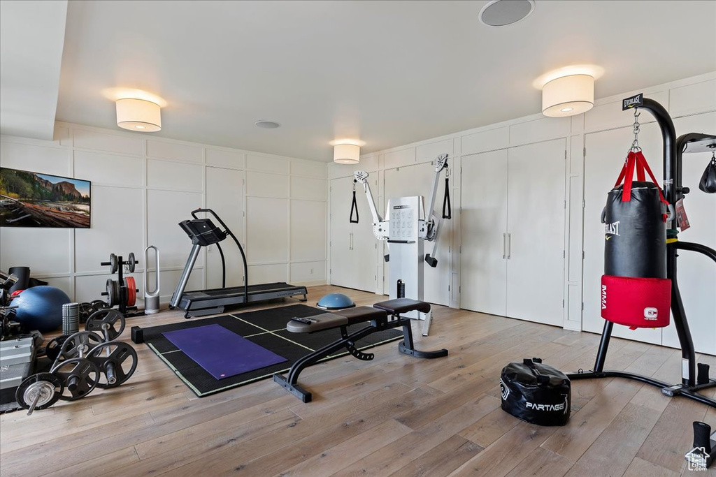 Exercise room with hardwood / wood-style floors