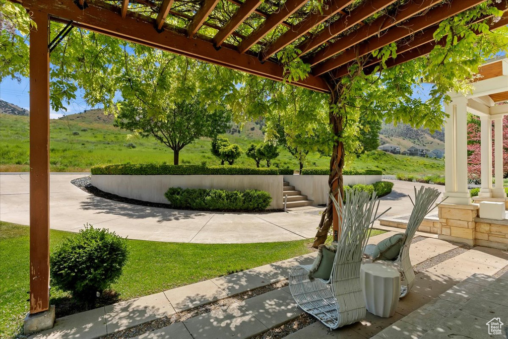 View of patio / terrace featuring a pergola and a mountain view