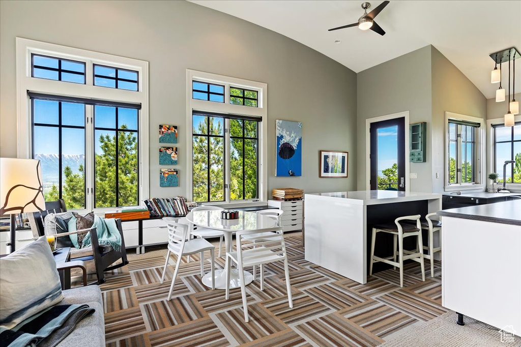 Interior space featuring high vaulted ceiling, plenty of natural light, and ceiling fan