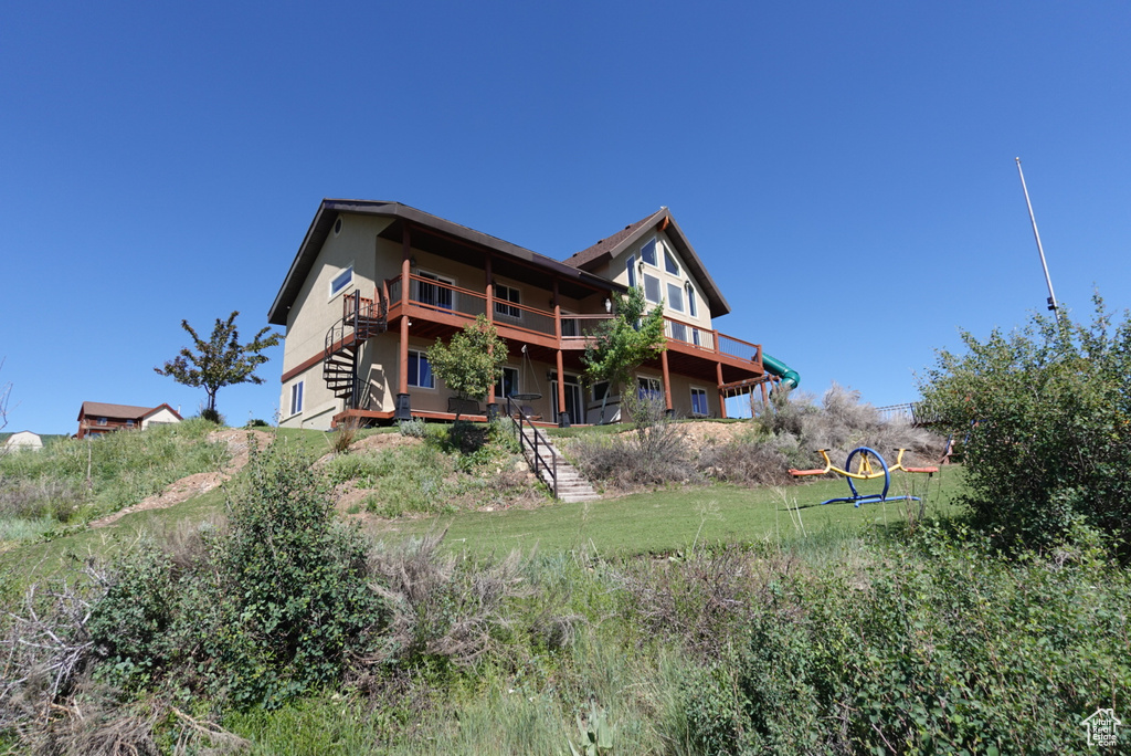 Rear view of property with a balcony