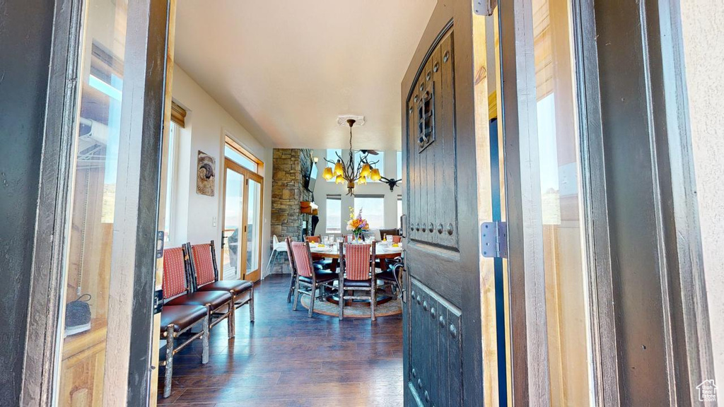 Dining room featuring a notable chandelier and dark wood-type flooring