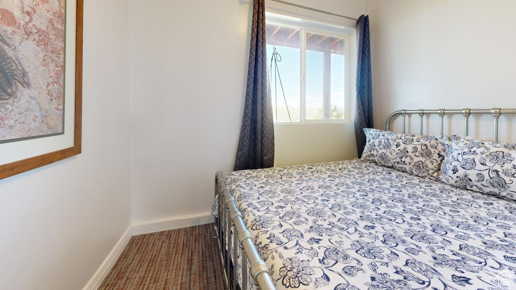 Bedroom with dark colored carpet