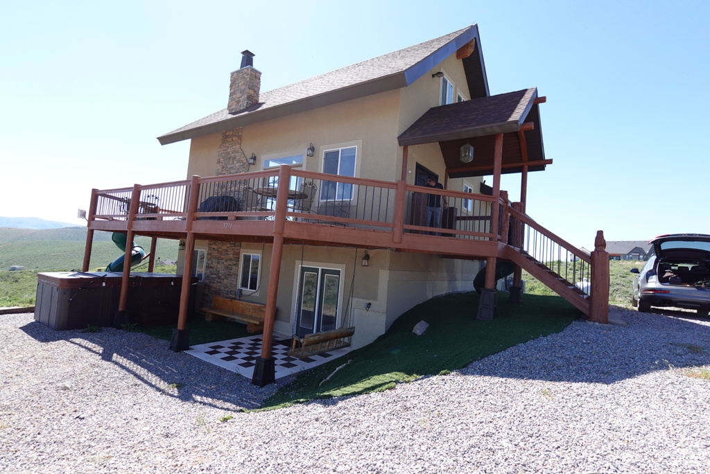 Back of house with a wooden deck