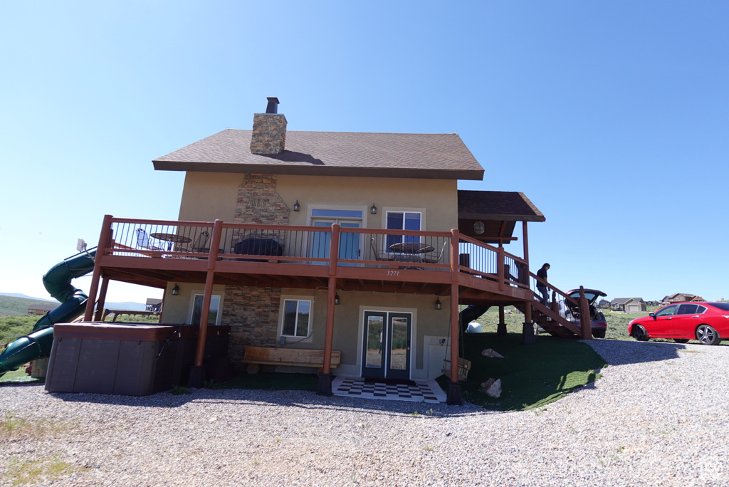 Rear view of property with a wooden deck