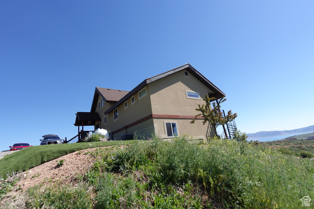 View of property exterior with central air condition unit