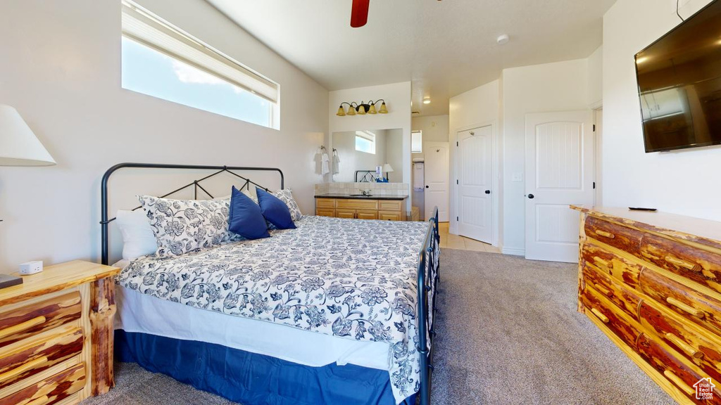 Carpeted bedroom with a closet and ceiling fan