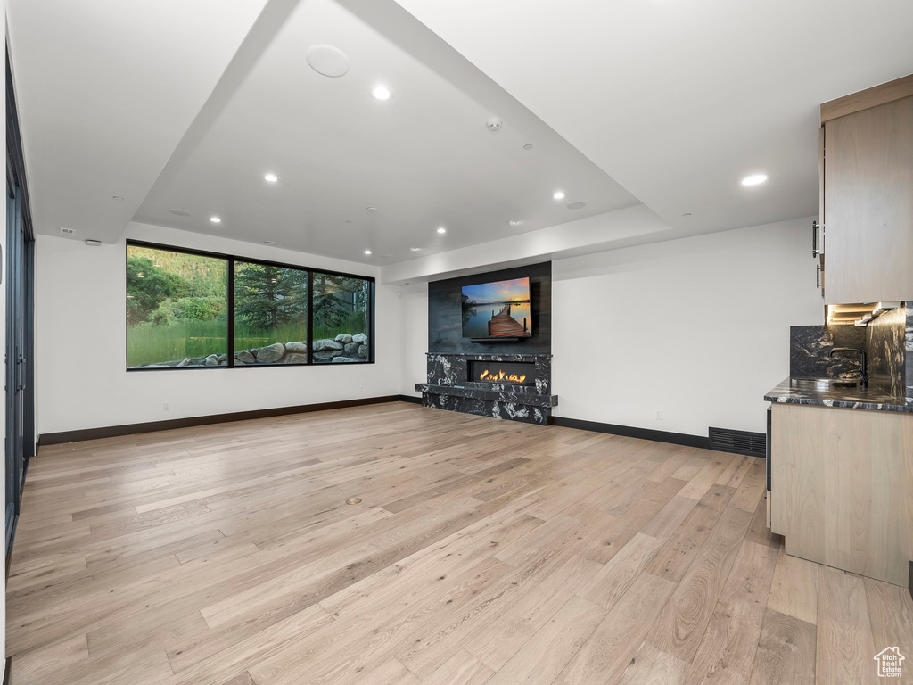 Unfurnished living room with light hardwood / wood-style flooring and a fireplace