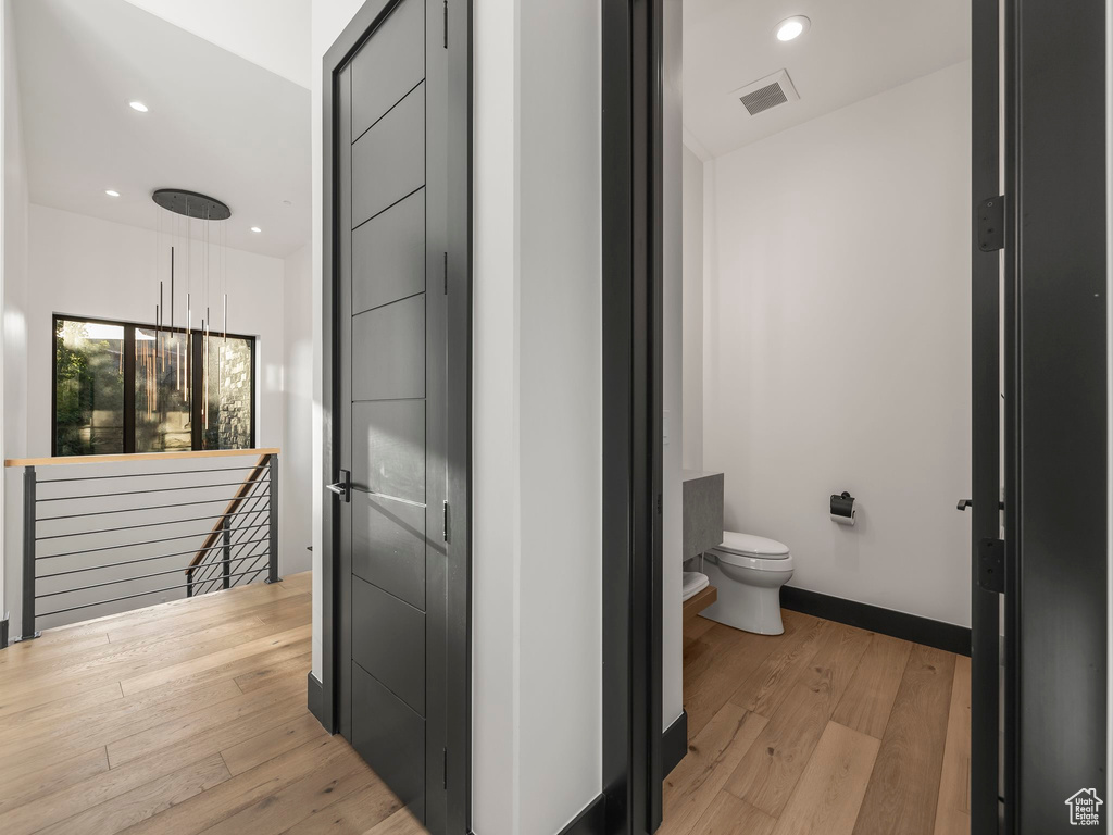 Bathroom with wood-type flooring and toilet