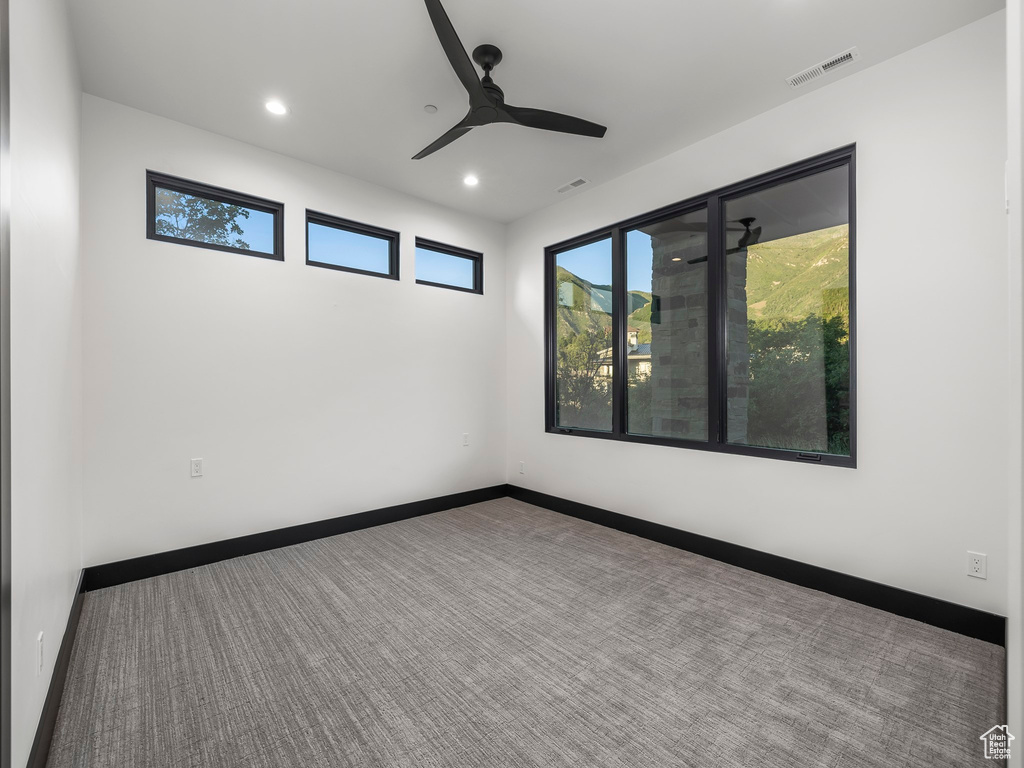 Unfurnished room with ceiling fan and carpet floors