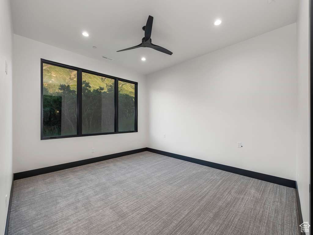 Unfurnished room with carpet floors and ceiling fan