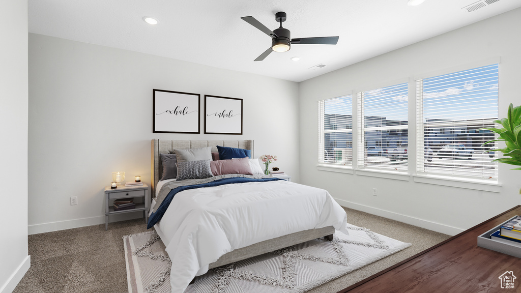 Carpeted bedroom featuring ceiling fan