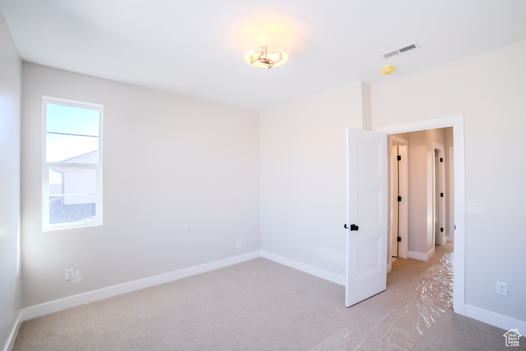 Unfurnished room with light colored carpet