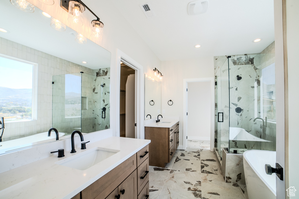 Bathroom with vanity and separate shower and tub