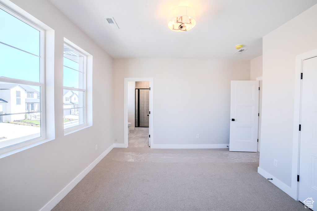 Spare room with light carpet and plenty of natural light