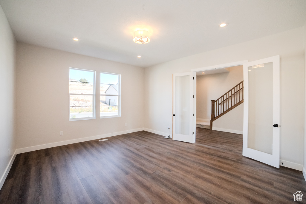 Unfurnished room with dark hardwood / wood-style floors