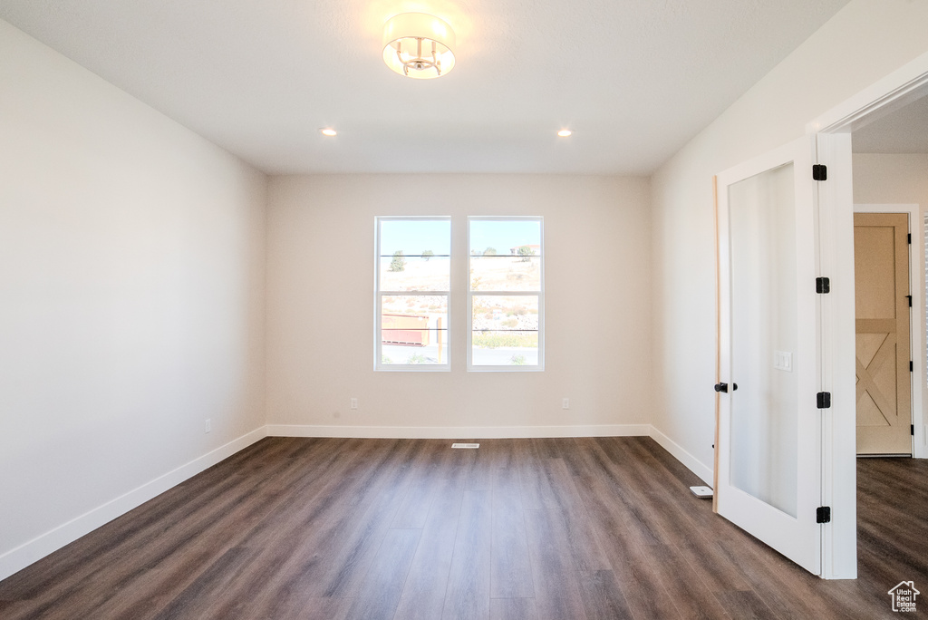 Unfurnished room with dark hardwood / wood-style floors