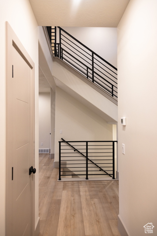 Staircase featuring wood-type flooring