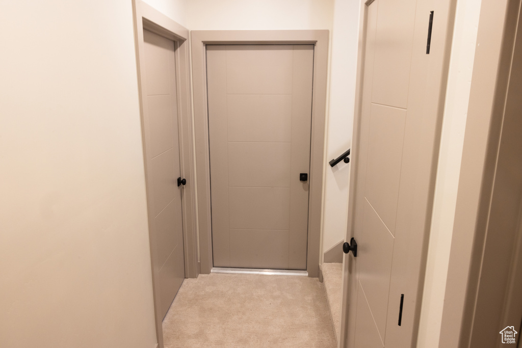 Hallway with light colored carpet