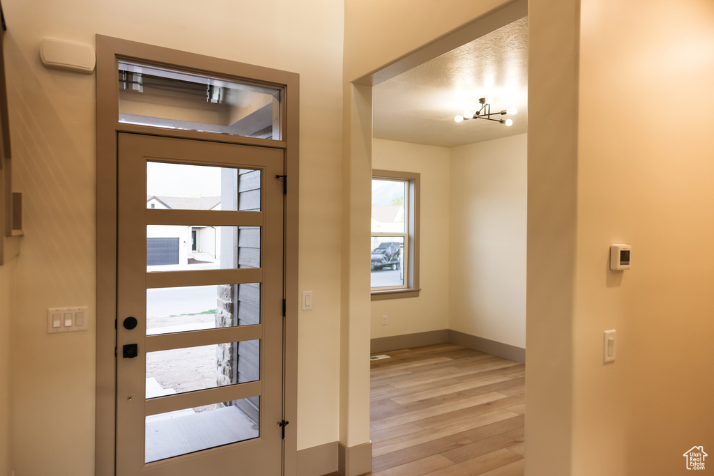 Foyer entrance with light wood-type flooring