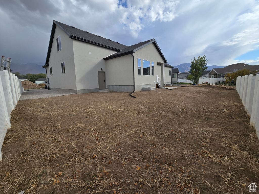 Back of house featuring a mountain view