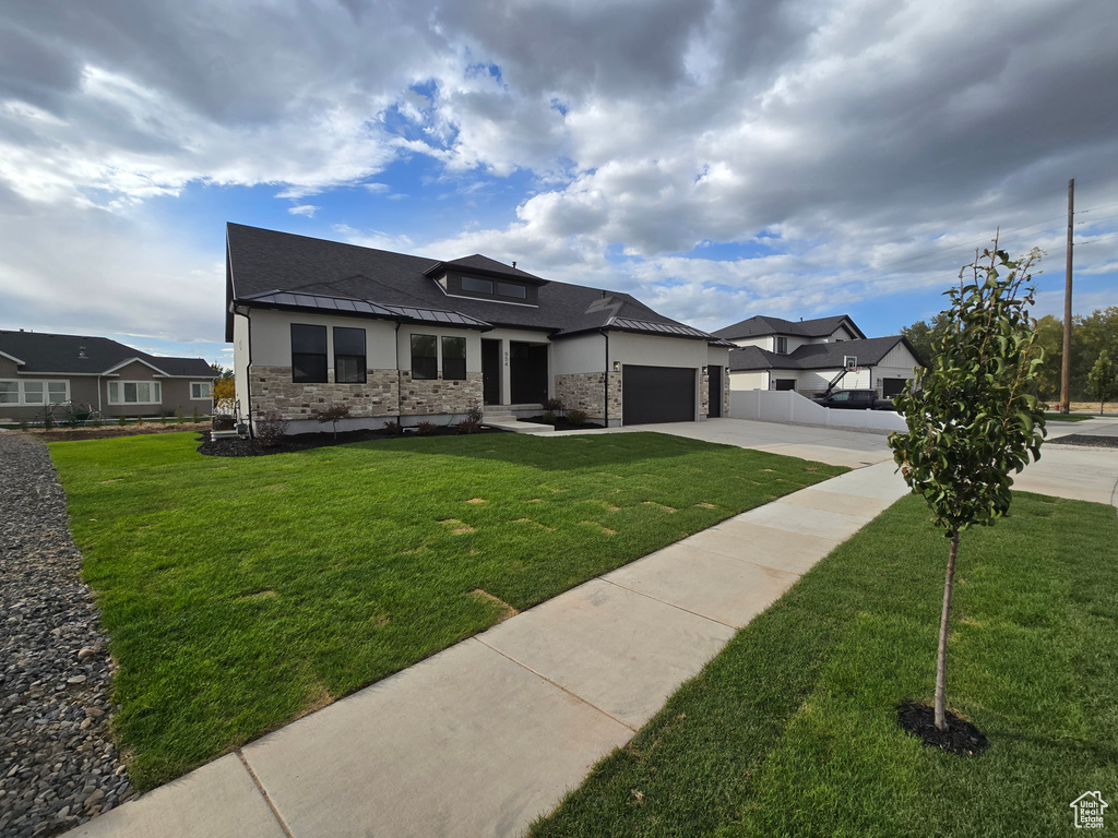 Prairie-style home with a front lawn and a garage