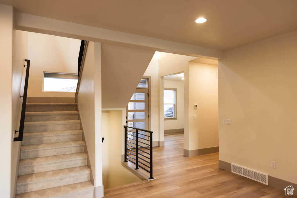 Stairway featuring wood-type flooring