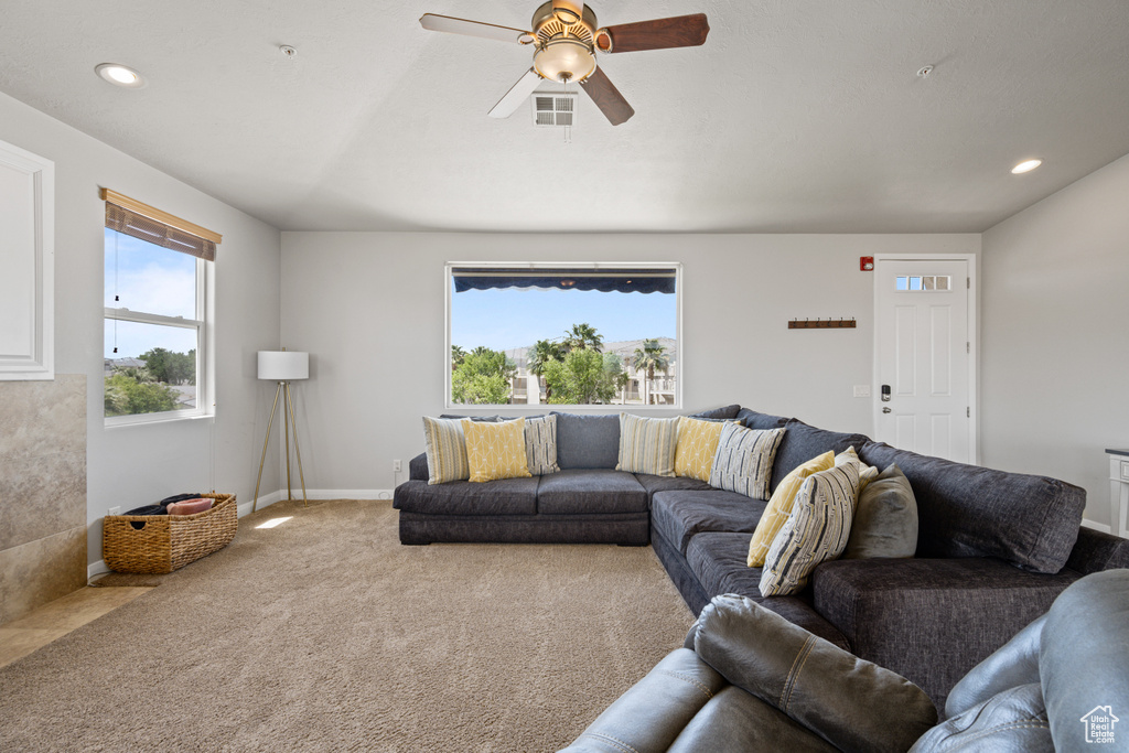 Living room featuring carpet flooring and ceiling fan