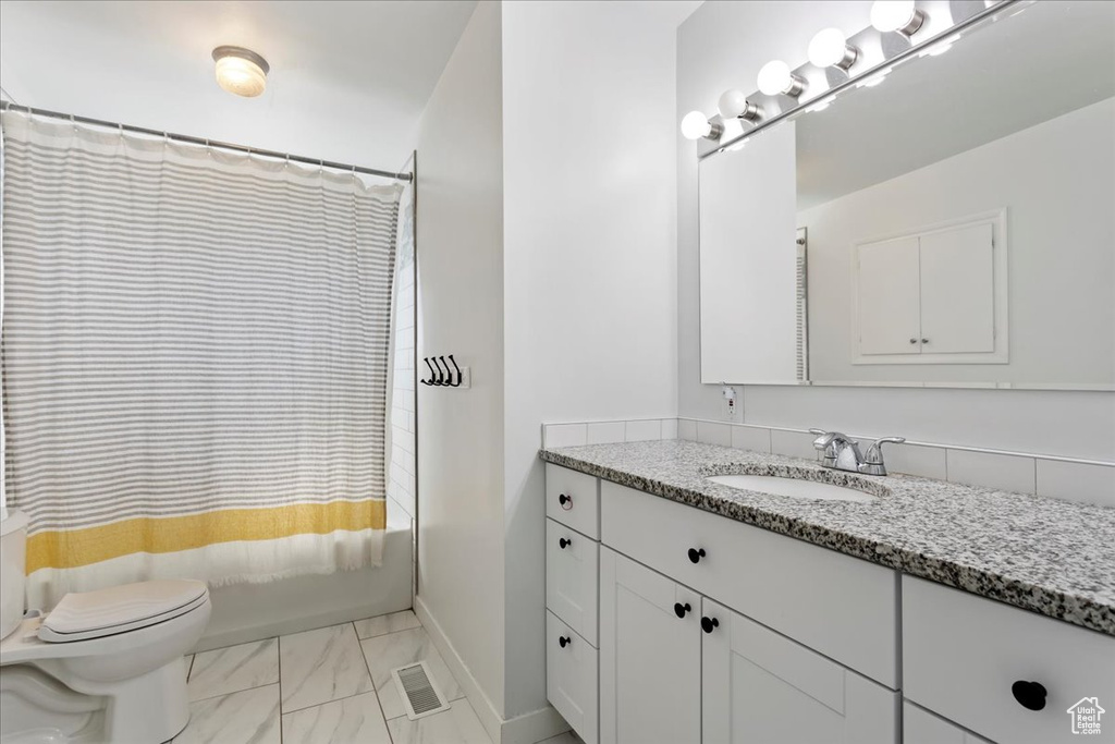 Bathroom with tile flooring, toilet, and vanity