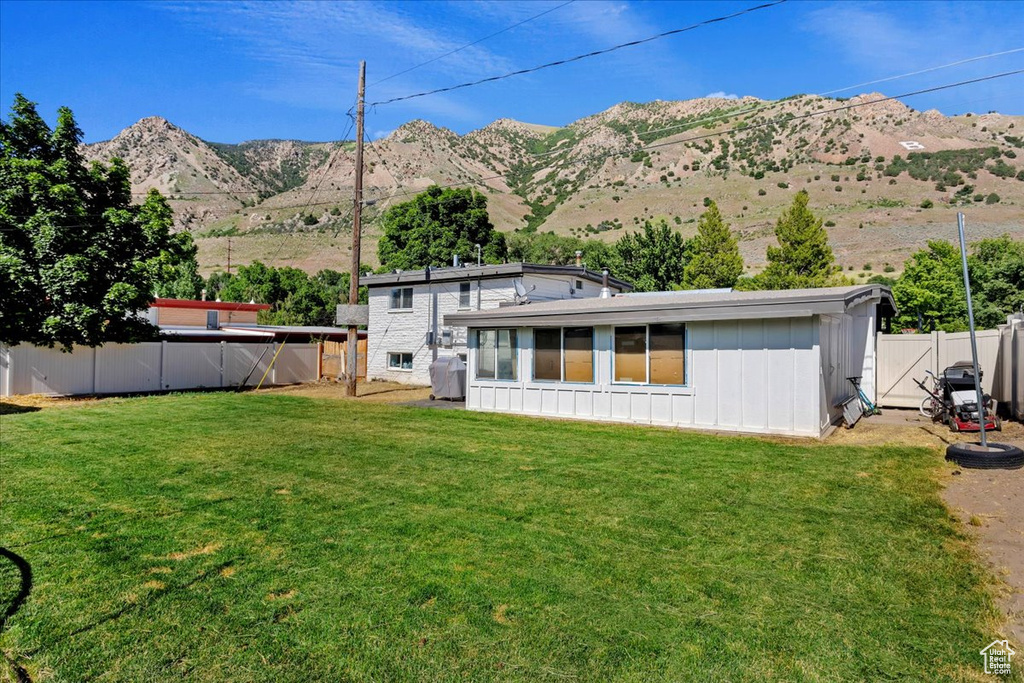 Exterior space with a mountain view and a yard