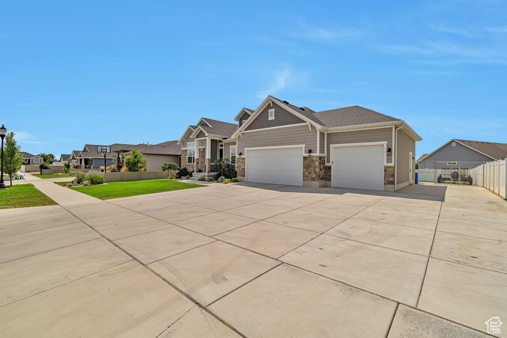 View of front of home featuring a front lawn and a garage