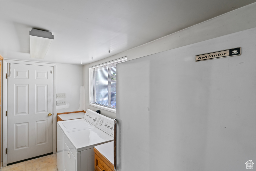 Washroom featuring light hardwood / wood-style floors and separate washer and dryer
