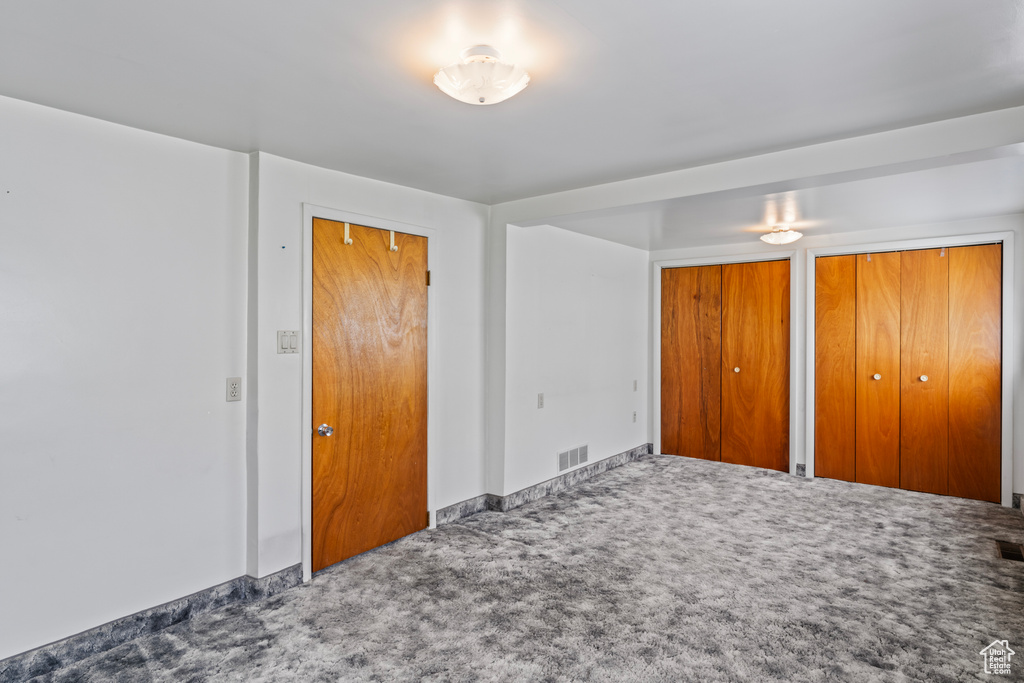 Bedroom with two closets and carpet flooring