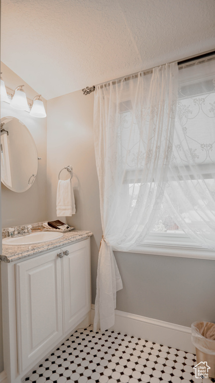 Bathroom with tile flooring and vanity