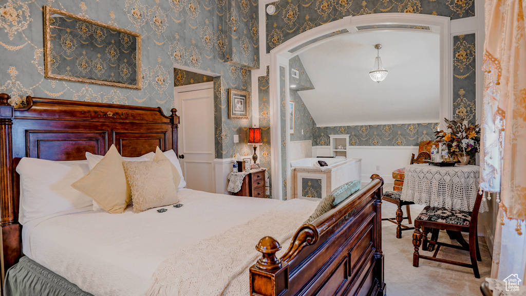 Bedroom with vaulted ceiling and carpet