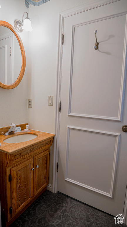 Bathroom with vanity with extensive cabinet space