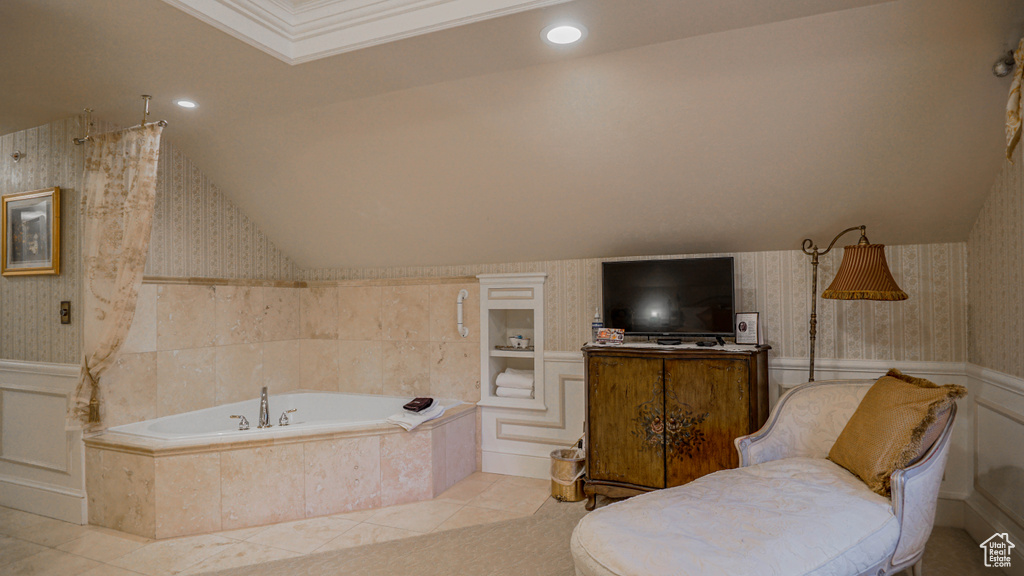 Bathroom featuring tile flooring and tiled bath